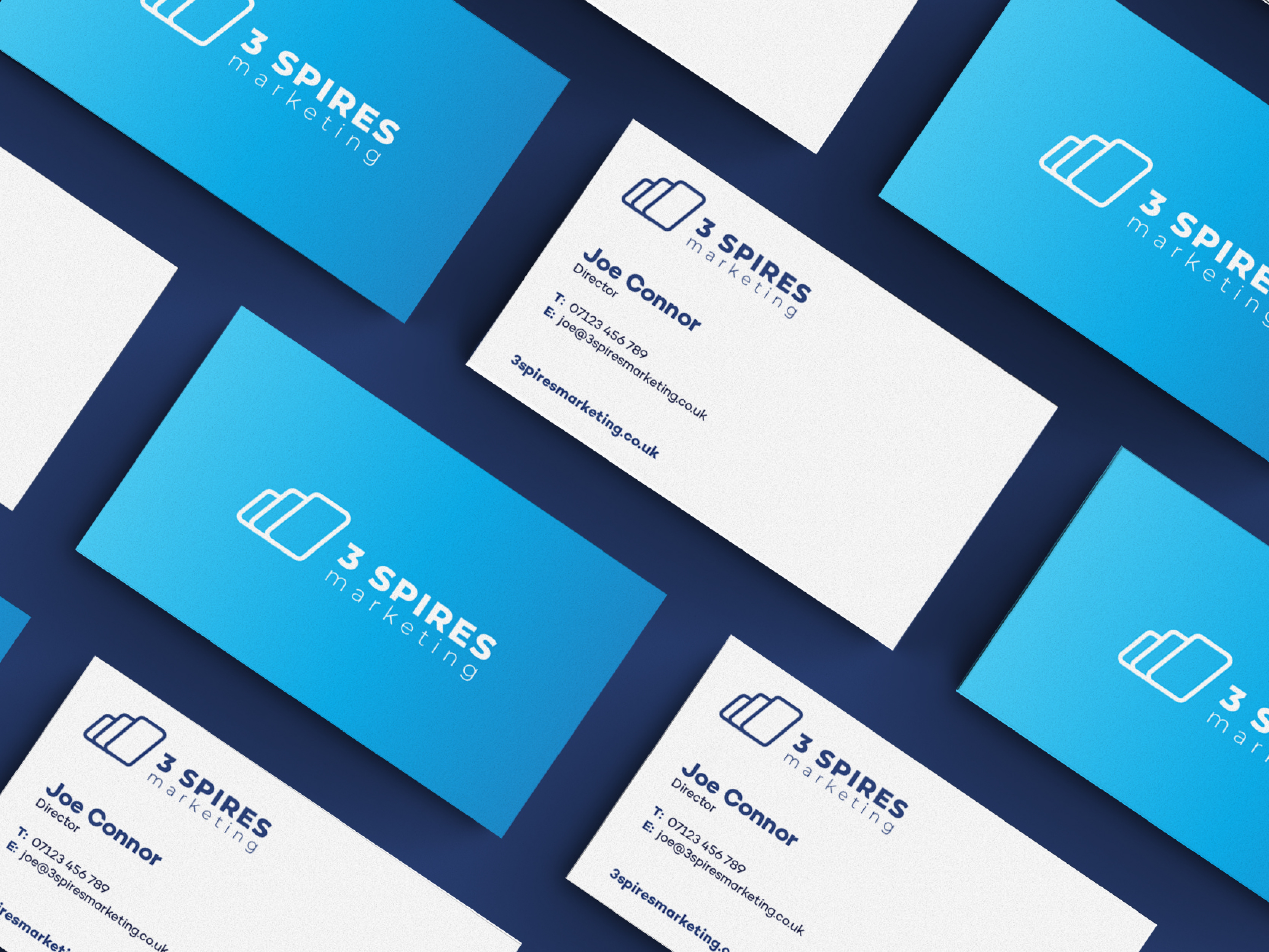 Business cards laying flat on a blue table